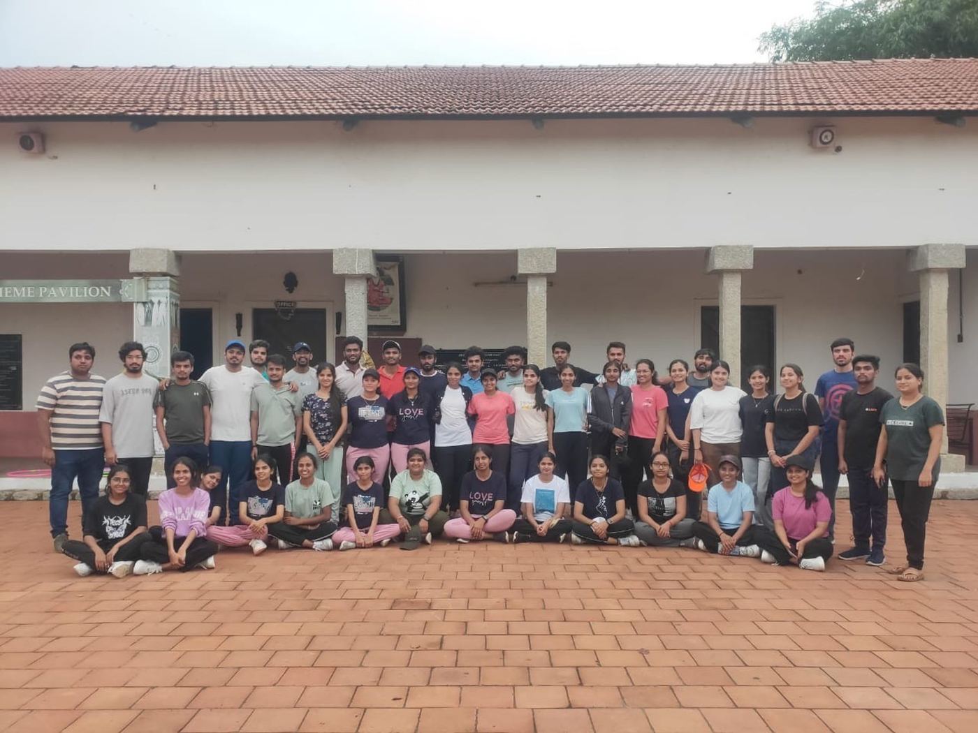 A college workshop group with Mysuru ADDA facilitators outside the camp pavilion